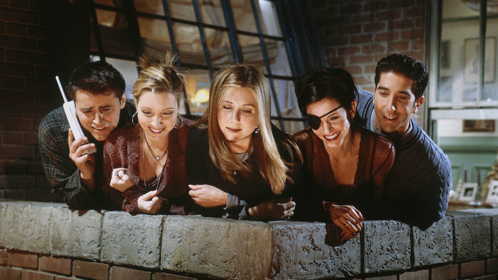 Joey Phoebe Rachel Monica with an eye patch and Ross looking down on the balcony in Friends Thanksgiving episode The One With The Box