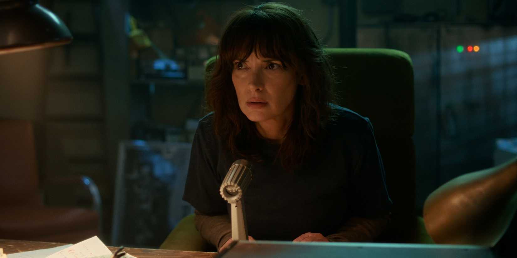 Joyce speaking into a microphone in Stranger Things