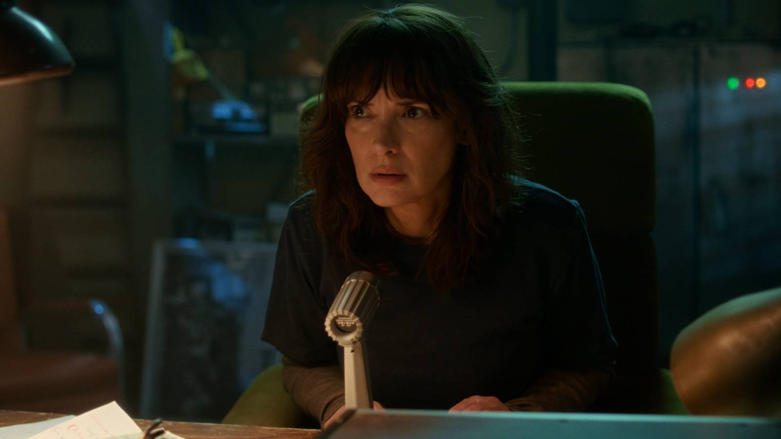 Joyce speaking into a microphone in Stranger Things