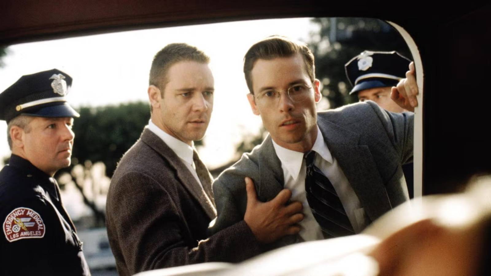 Russell Crowe holds back Guy Pierce as he looks at a dead body in LA Confidential 