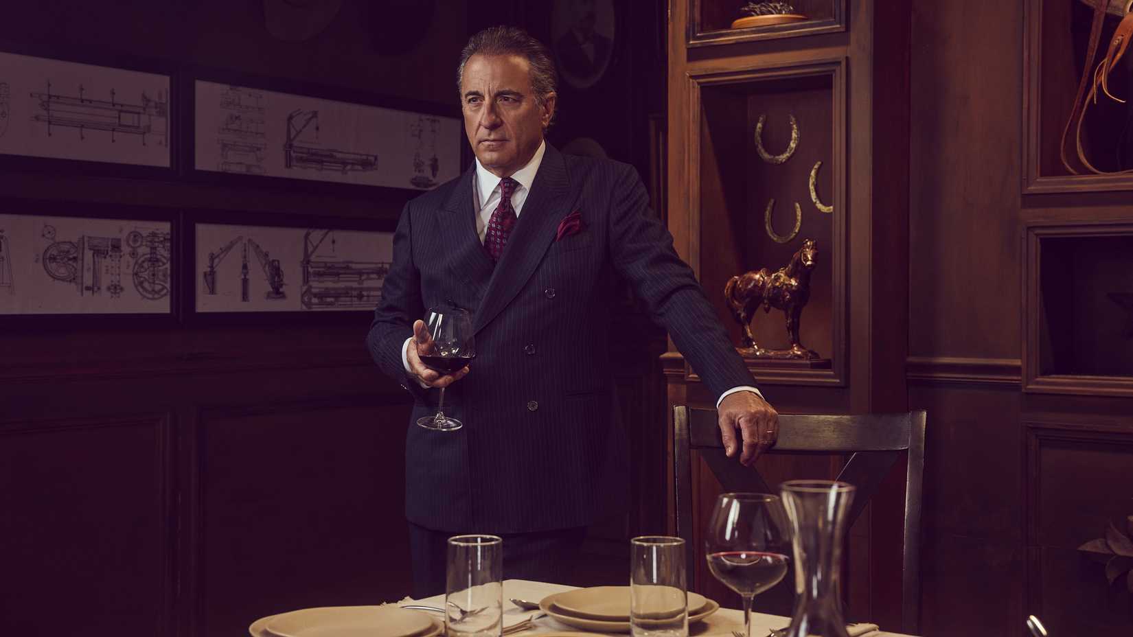 Gallino/Dan Morrell (Andy Garcia) holding a wine glass while standing over a fancy table in Landman season 2