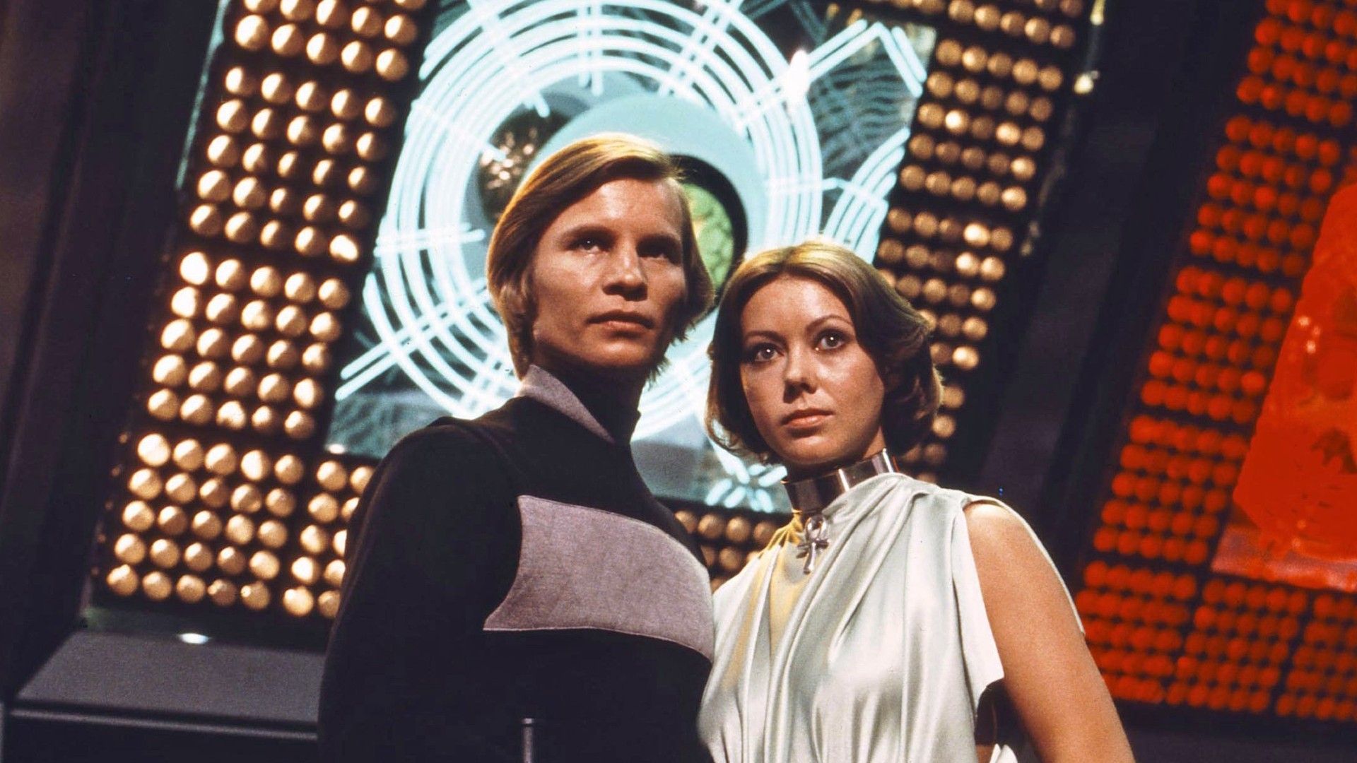 Michael York e Jenny Agutter davanti a un grande computer rosso in Logan's Run