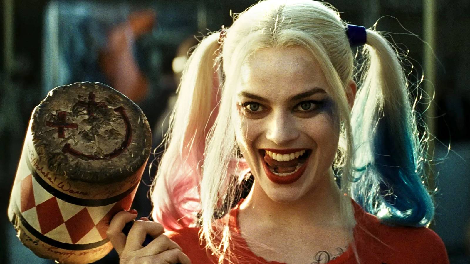 Margot Robbie's Harley Quinn sticks her tongue out holding a hammer in Suicide Squad
