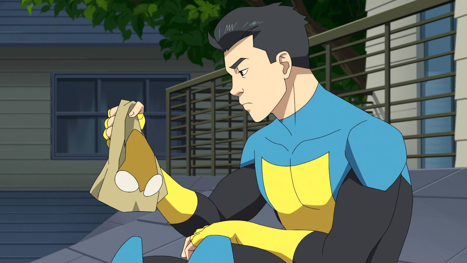 Mark Grayson sitting on his balcony while holding his mask and looking mentally exhausted in Invincible