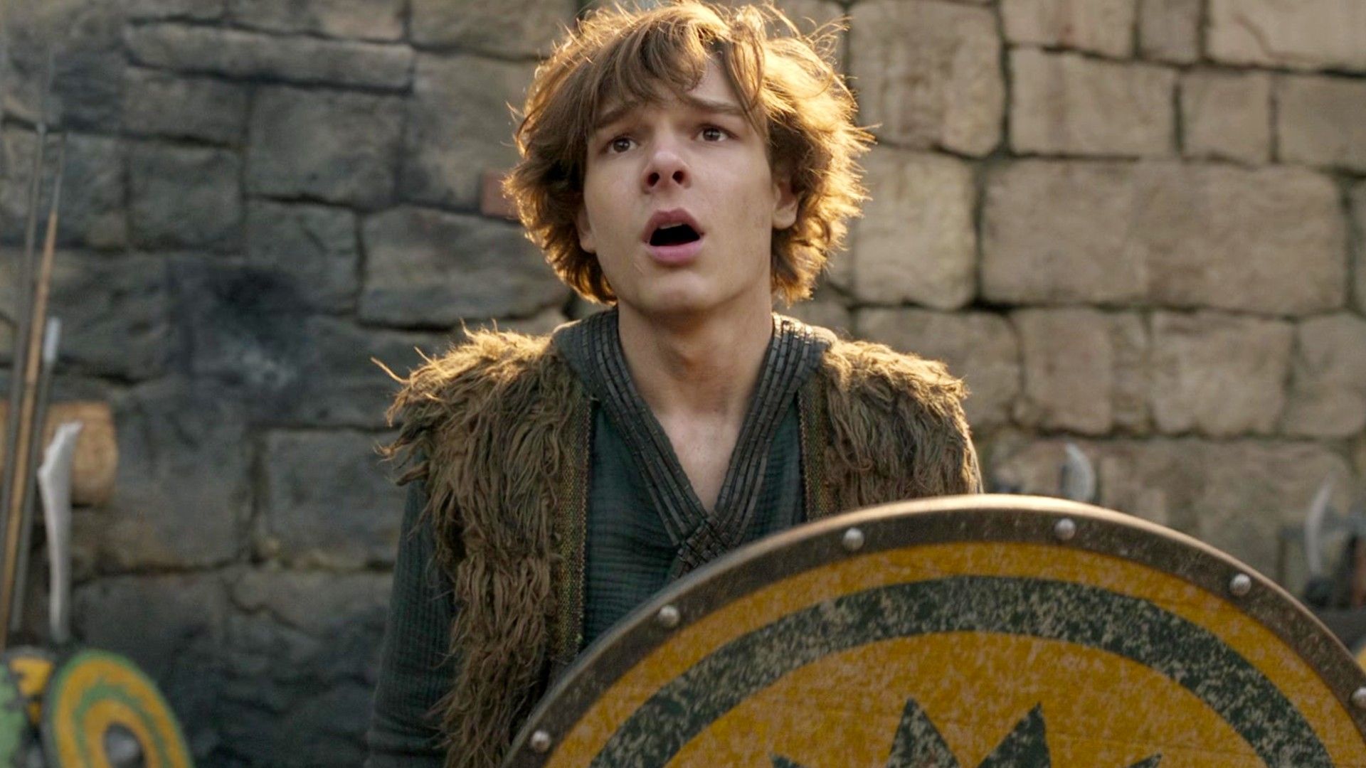 Mason Thames as Hiccup holding a shield in How to Train Your Dragon