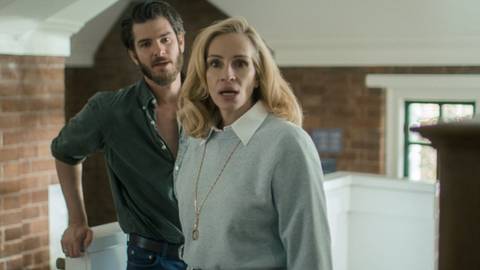 Julia Roberts looking concerned while Andrew Garfield stands behind her in After the Hunt
