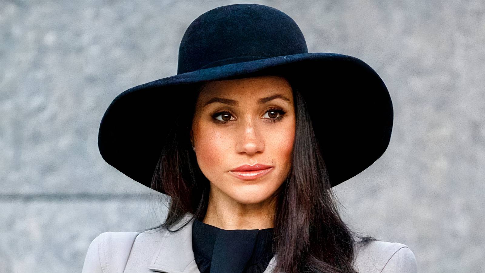 Meghan Markle wearing black hat.