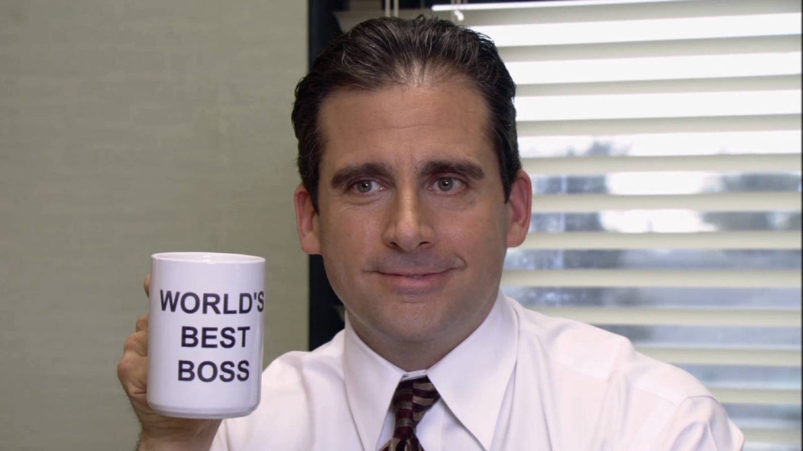 Michael Scott holding a World's Best Boss mug in The Office