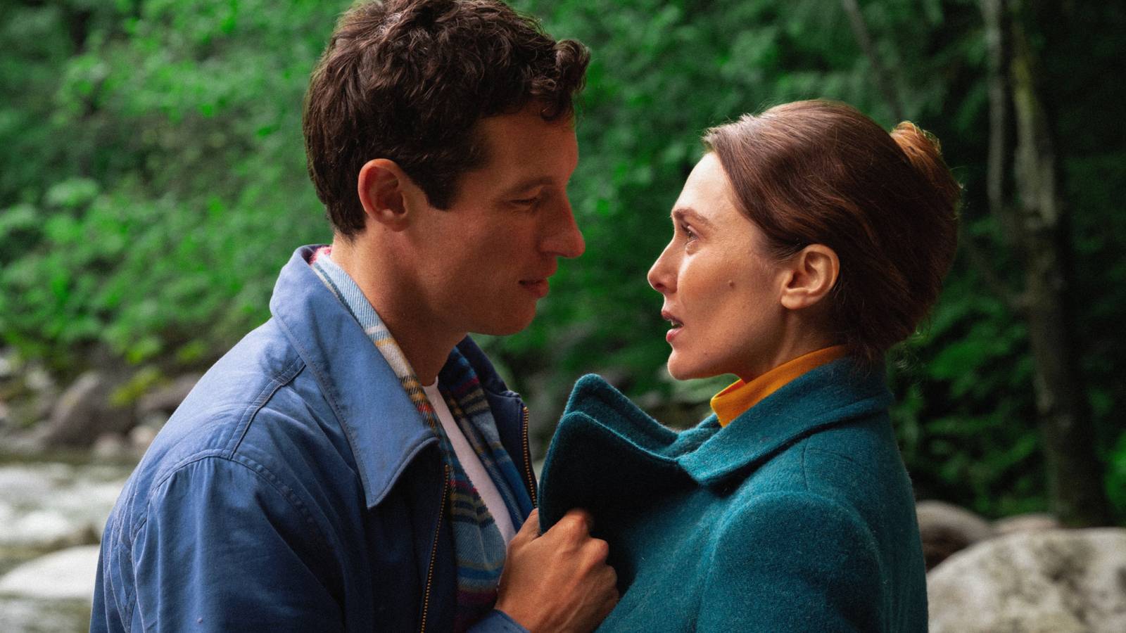 Miles Teller and Larry and Elizabeth Olsen as Joan looking at each other in Eternity