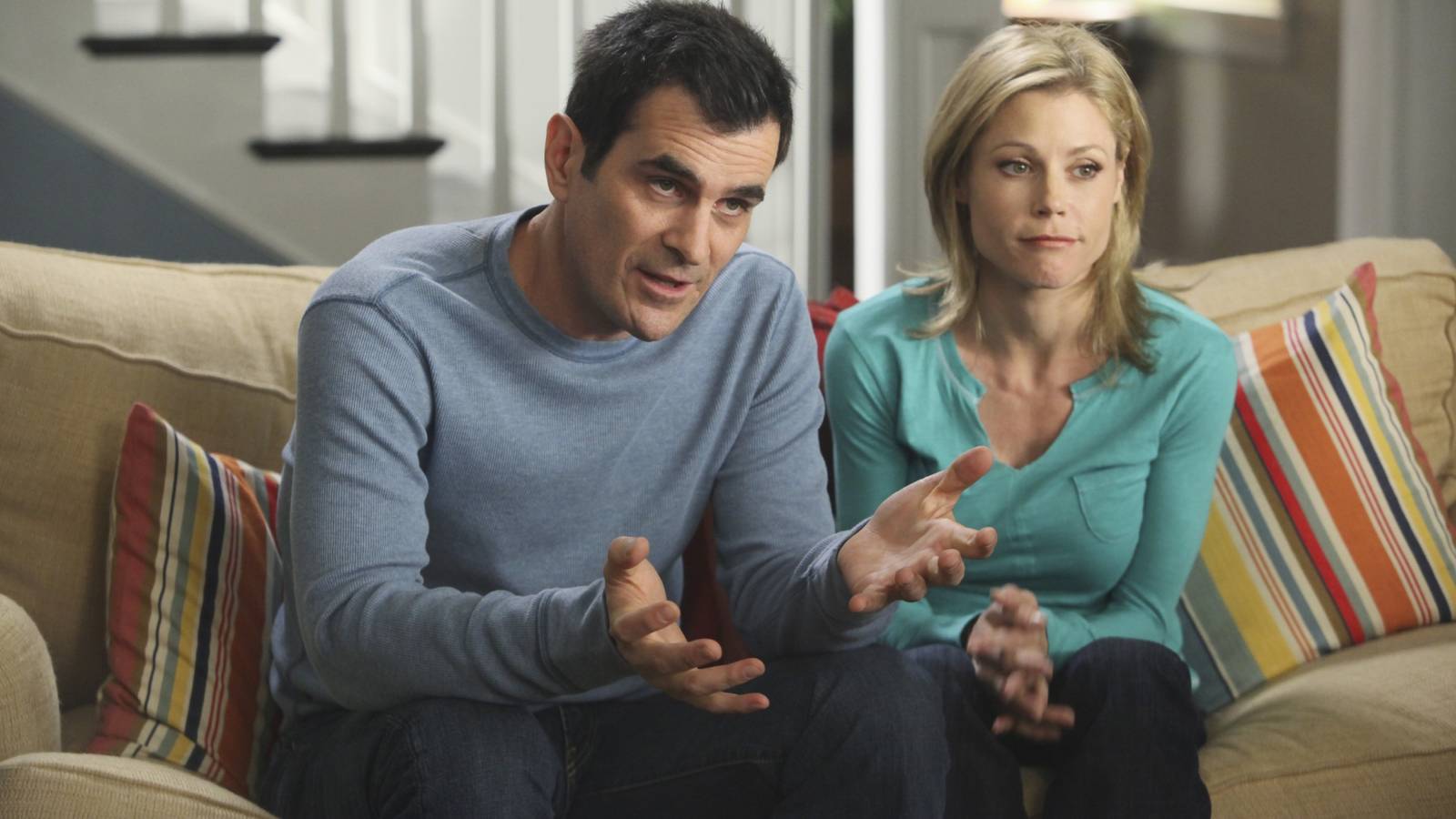 Phil and Claire Dunphy on the couch in their house on Modern Family