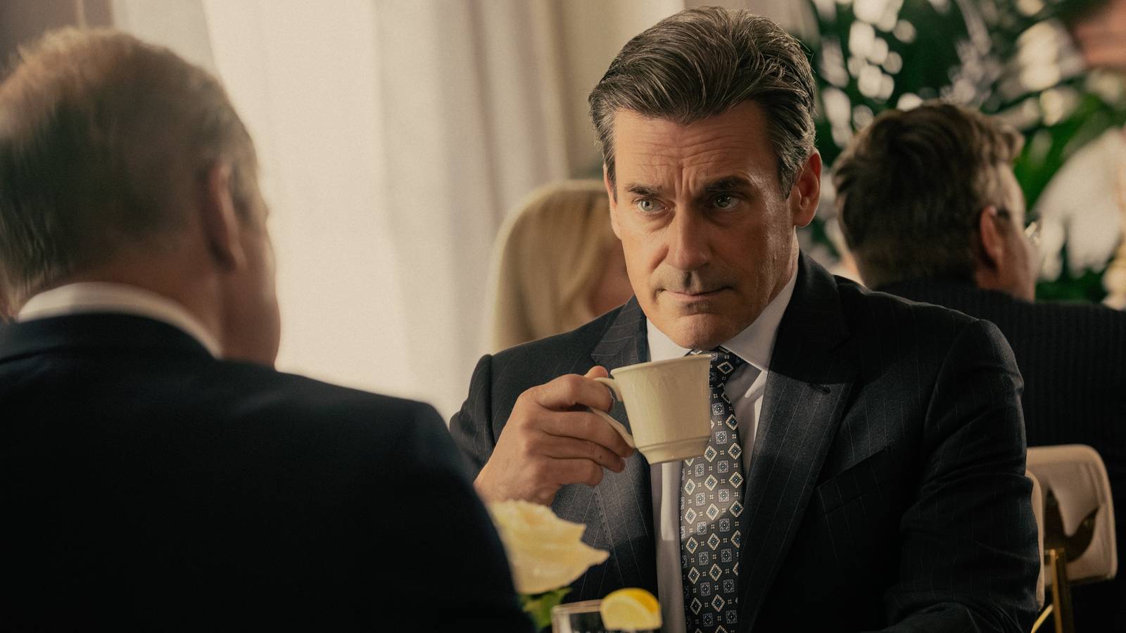 Monty Miller (Jon Hamm) sipping coffee while looking concerned in Landman season 1.