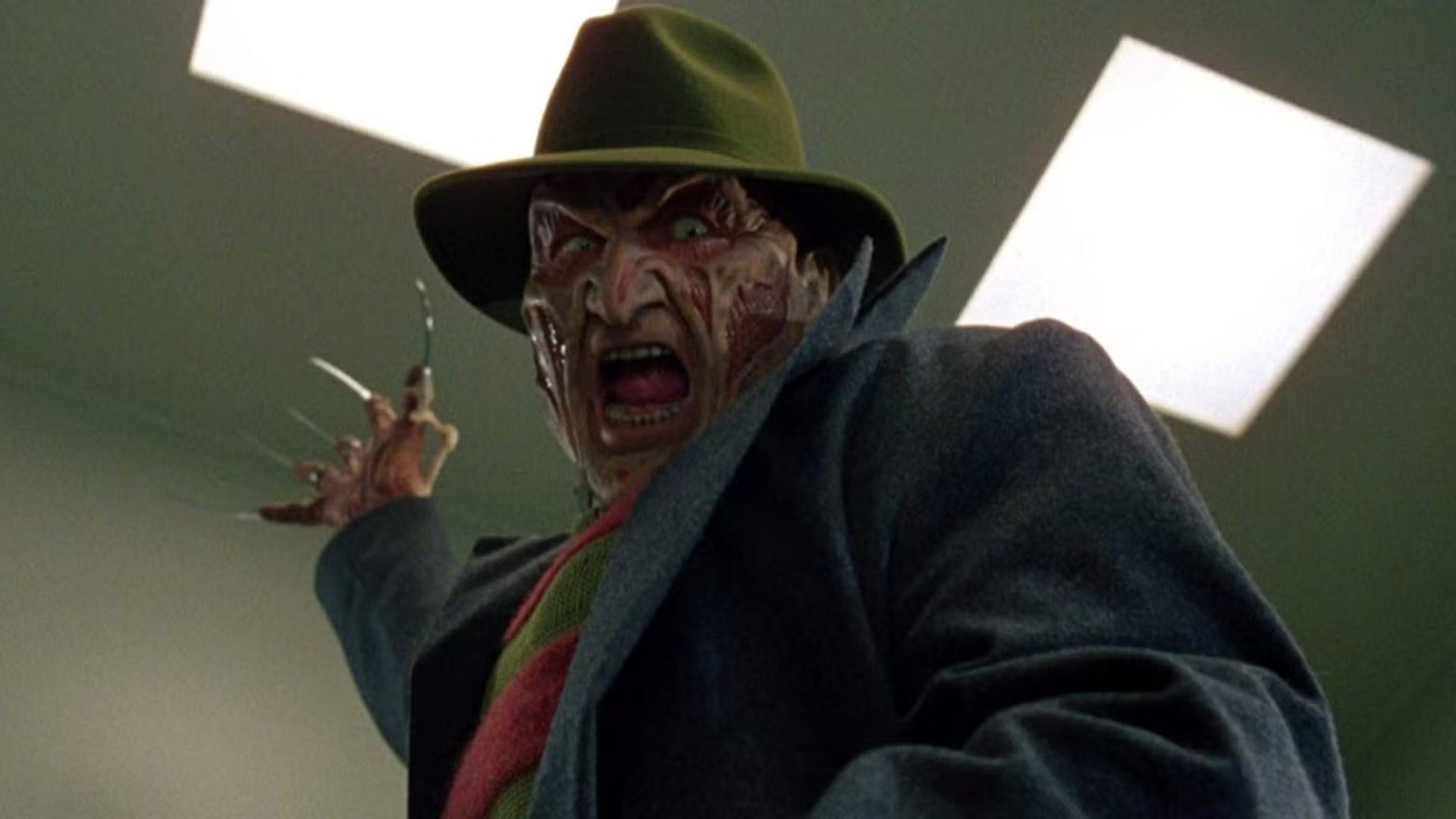 Freddy raises his glove with a shout in Wes Craven's New Nightmare