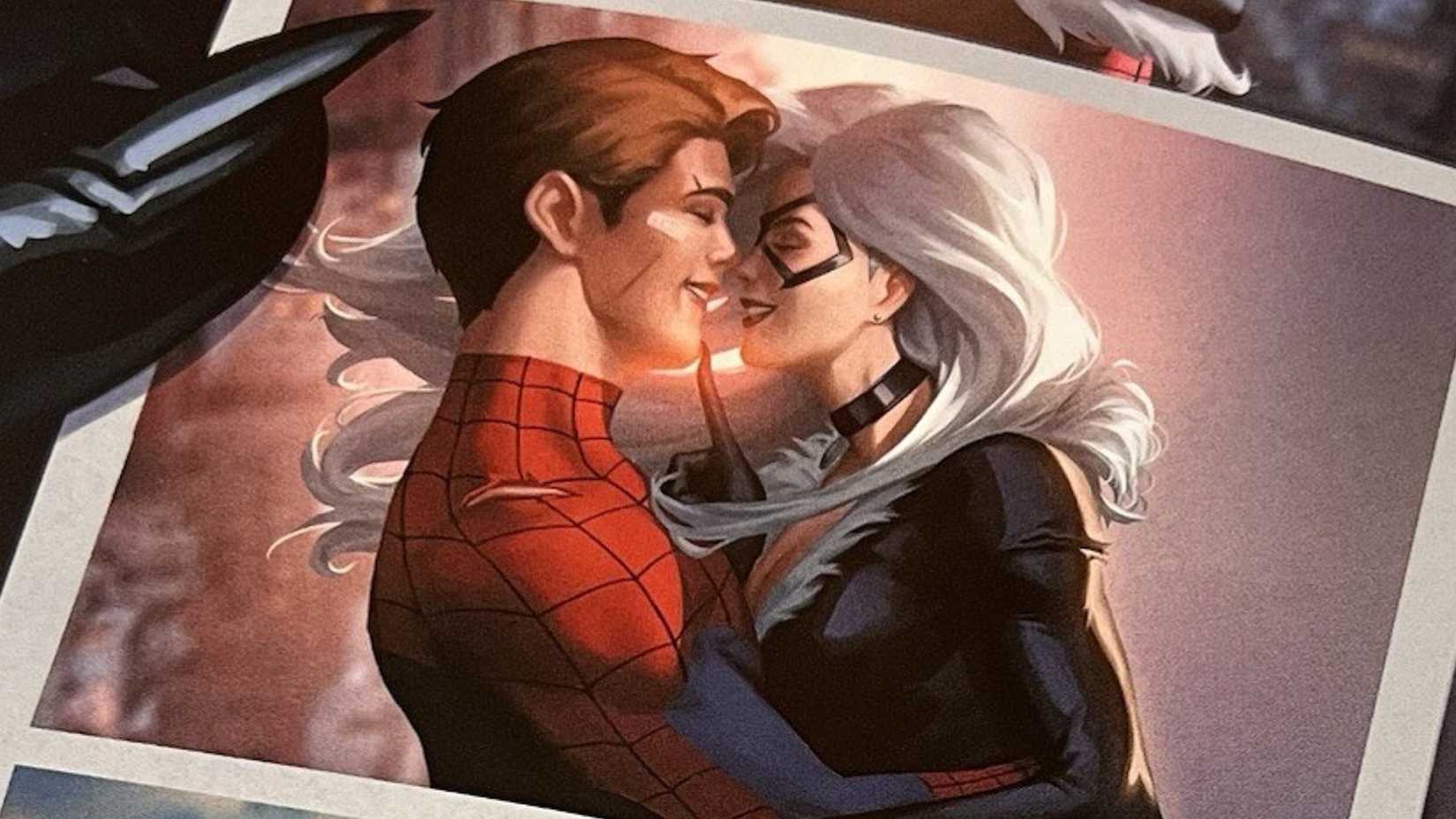Peter Parker and Black Cat smile while hugging in a photo held by Felicia Hardy in Spider-Man comic cover