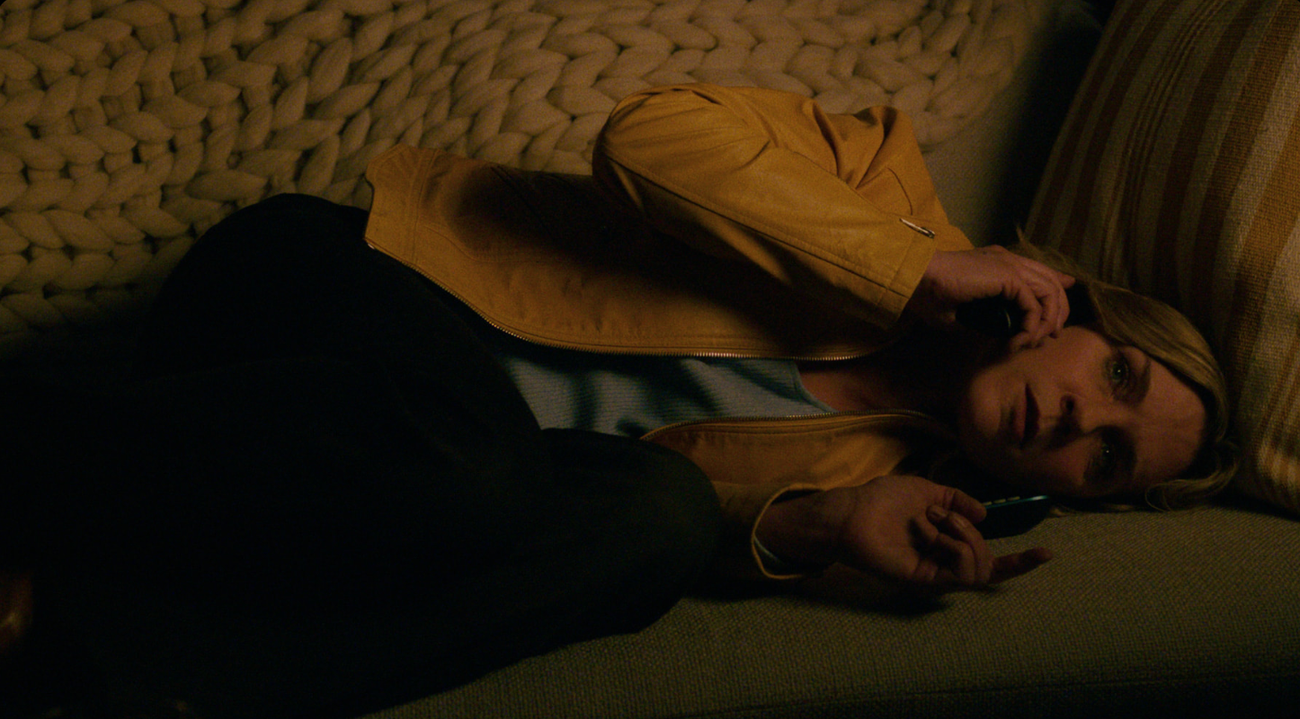 Carol laying down while on the phone in Pluribus.