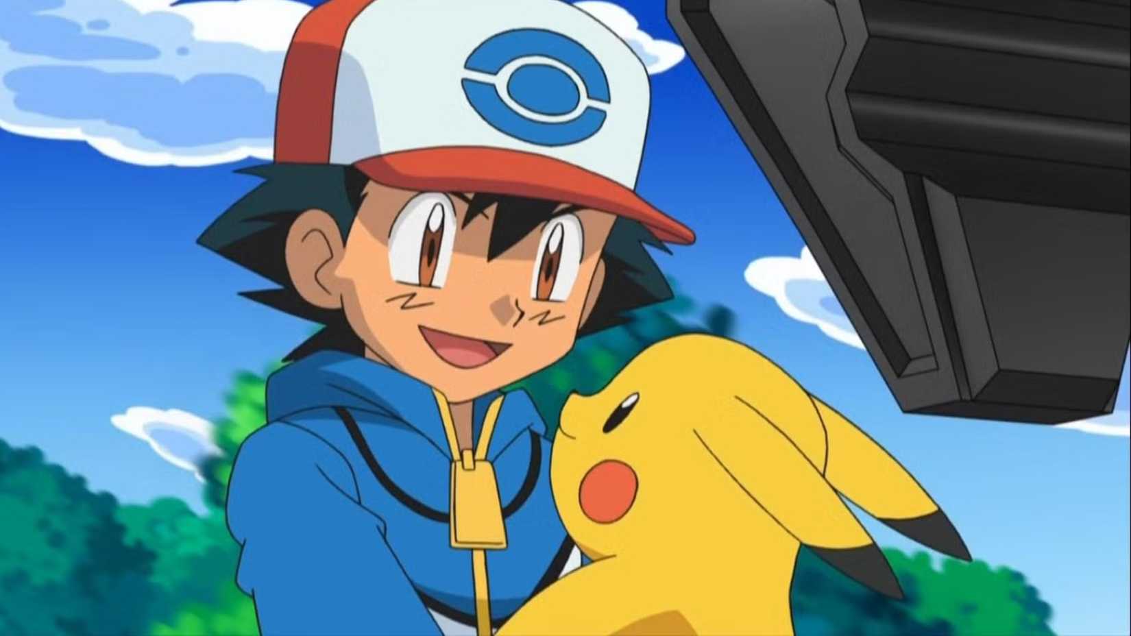 Ash from Pokémon is holding Pikachu and smiling at him.