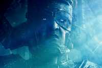 Ralph Ineson's Galactus sits on his throne lit by a dim light in The Fantastic Four First Steps image