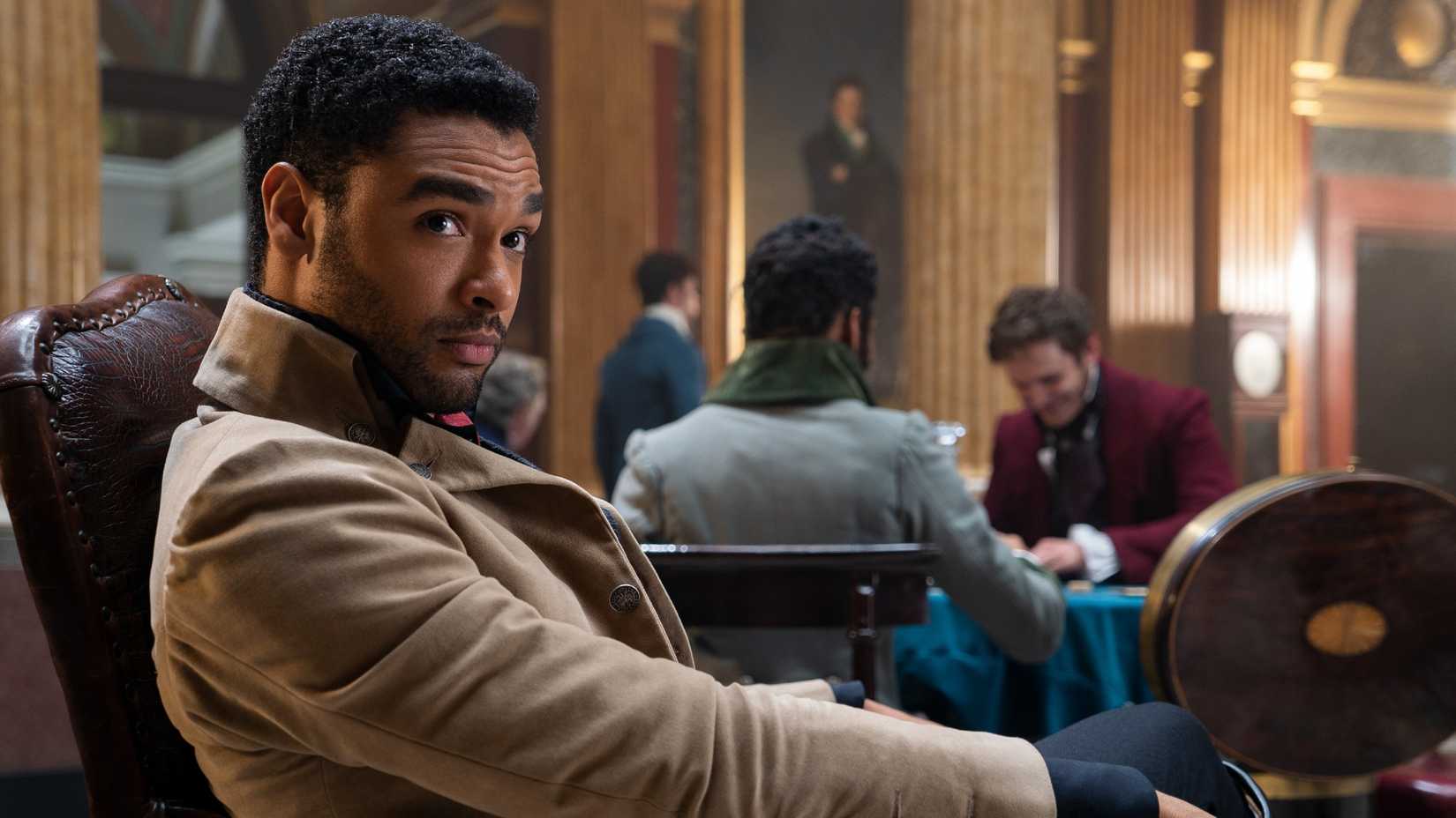 Regé-Jean Page sitting in a chair as Simon on Bridgerton.