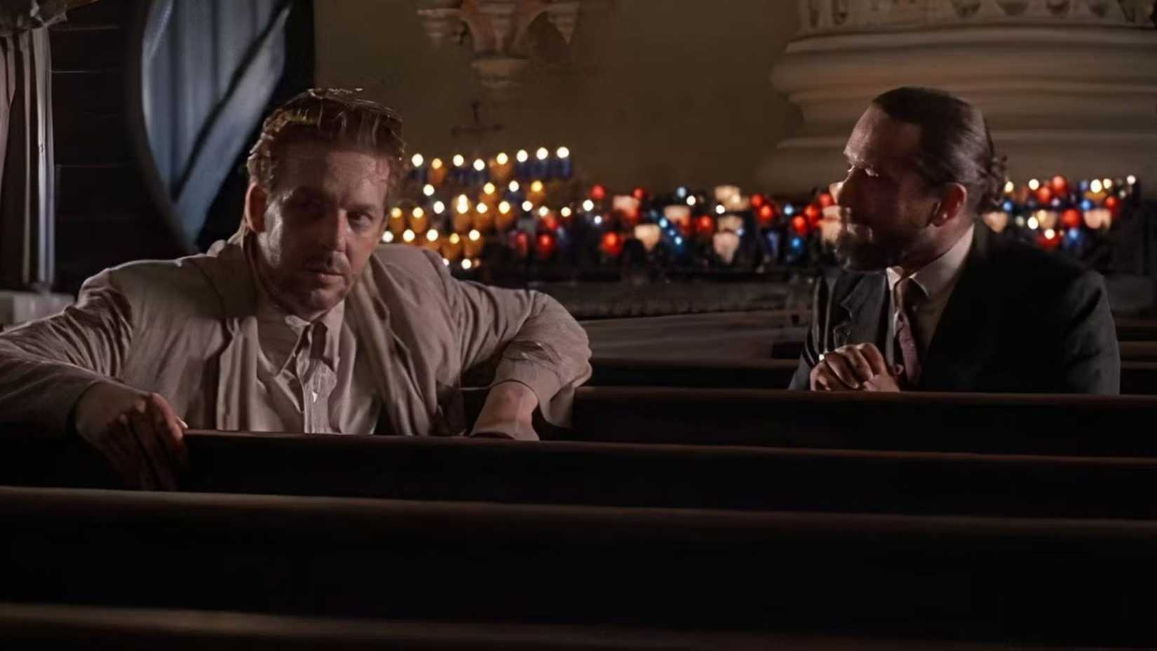 Robert De Niro as Harry Angel and Mickey Rourke as Louis Cyphre talking in a church in Angel Heart