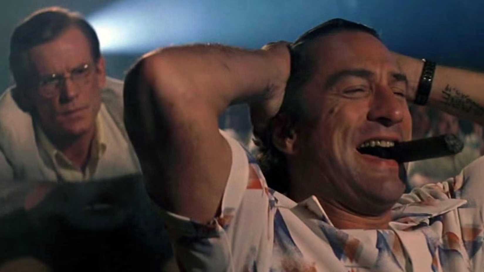Robert De Niro laughing in a movie theater in Cape Fear