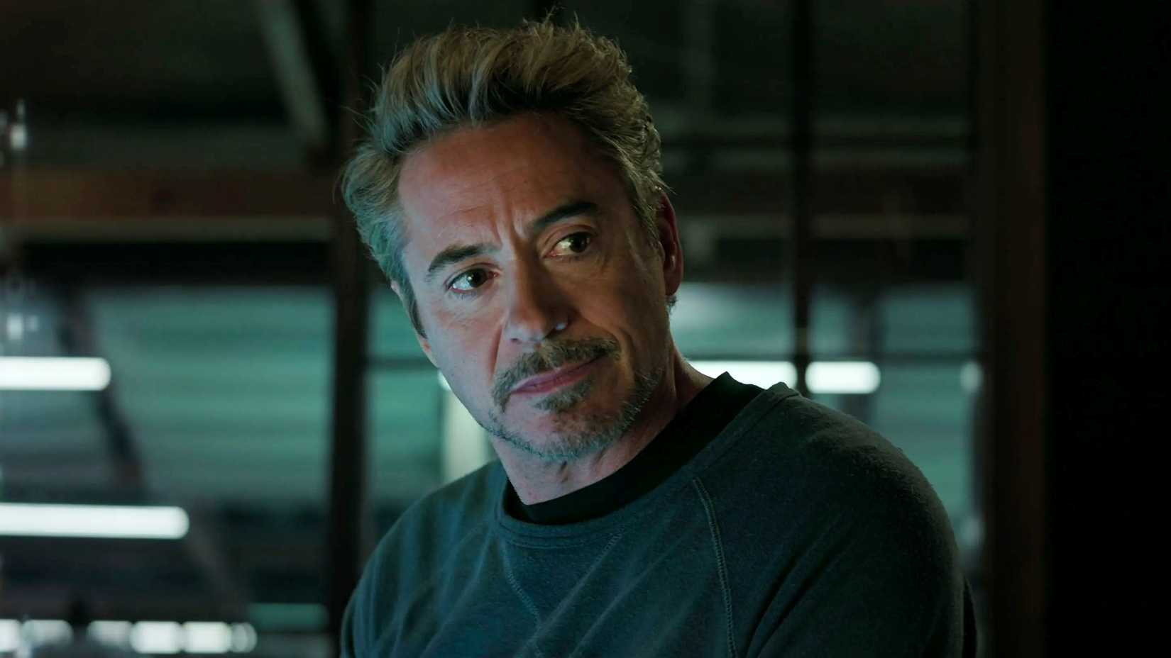 Robert Downey Jr.'s Tony Stark looking deep in thought at Morgan Stark in Avengers: Endgame