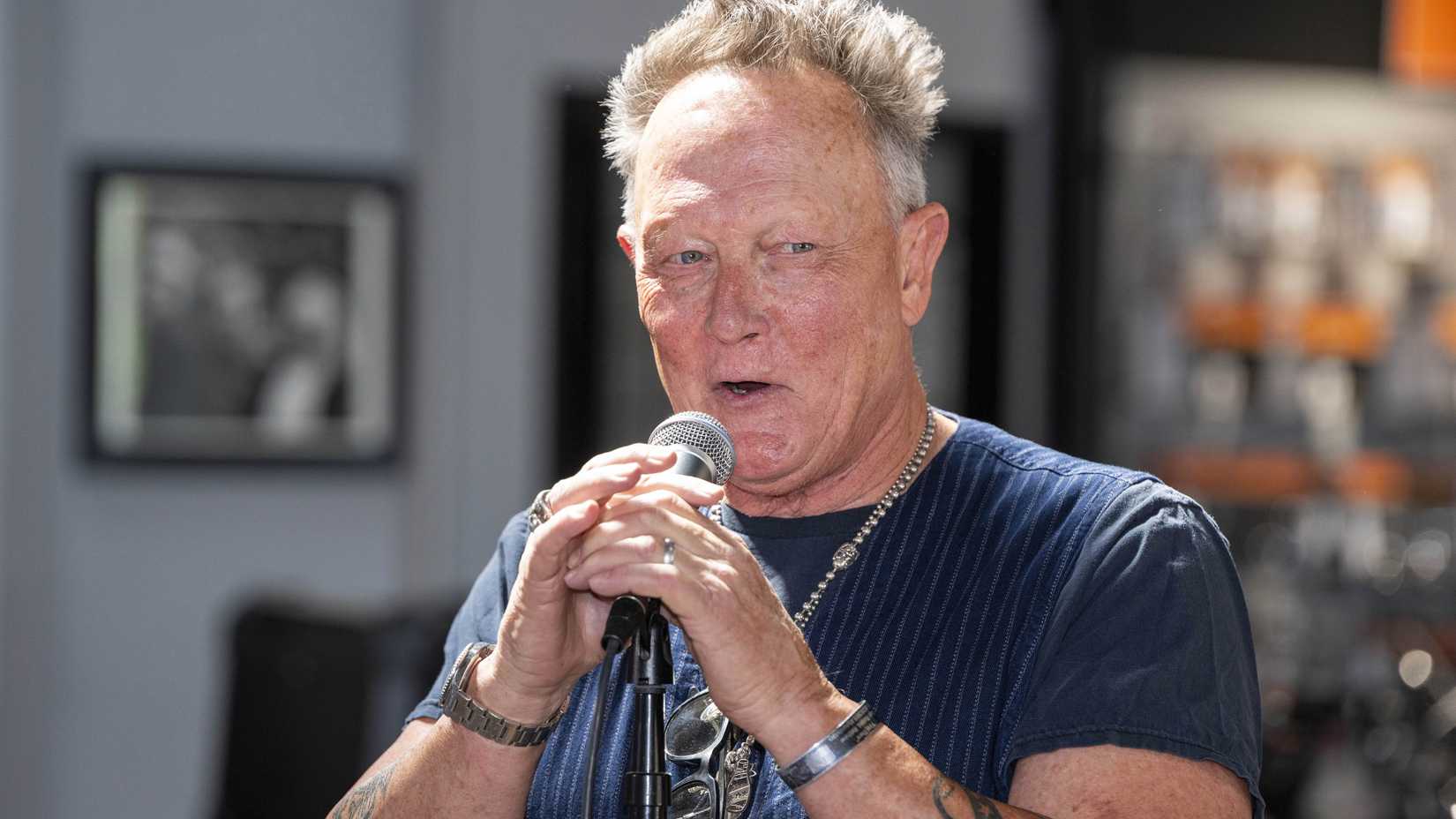 robert patrick smiling while talking into a microphone at a love ride 34 event