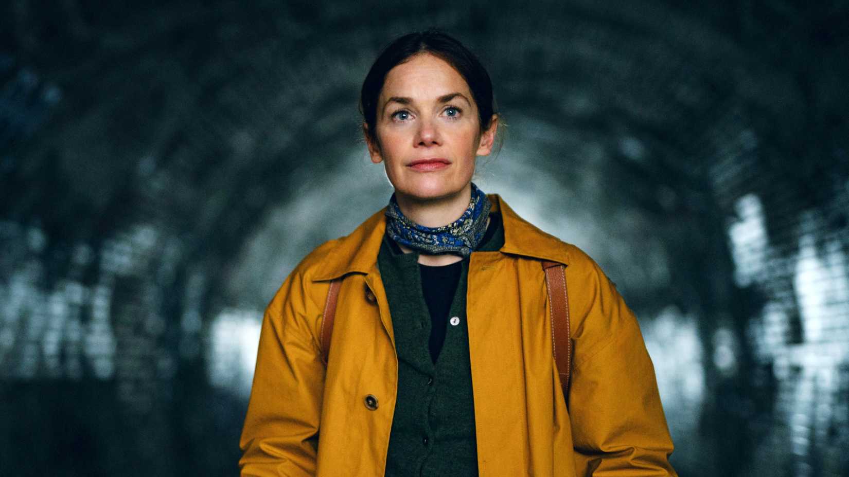 Ruth Wilson looking inquisitive in a yellow coat in Down Cemetery Road