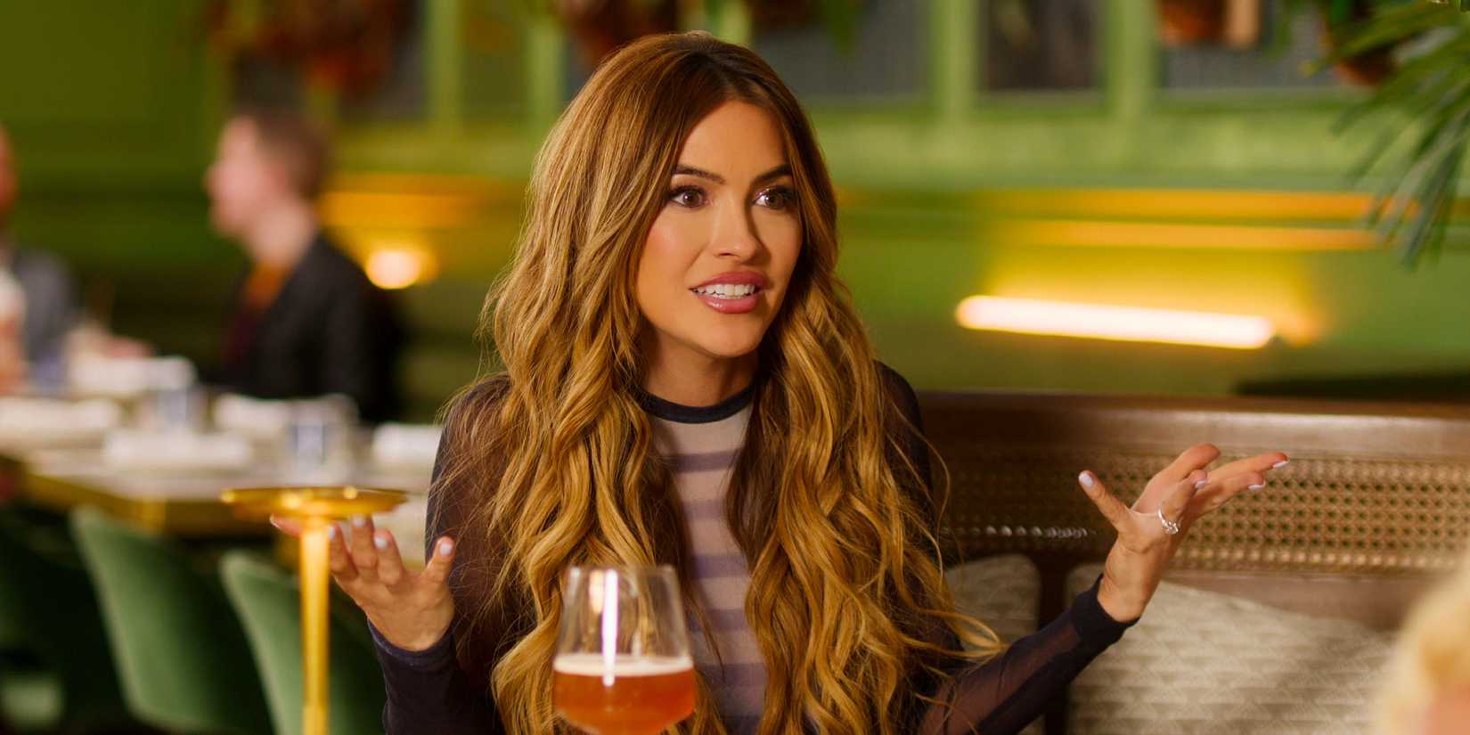 Selling Sunset's Chrishell Stause looking irritated and holding up her hands in confusion.