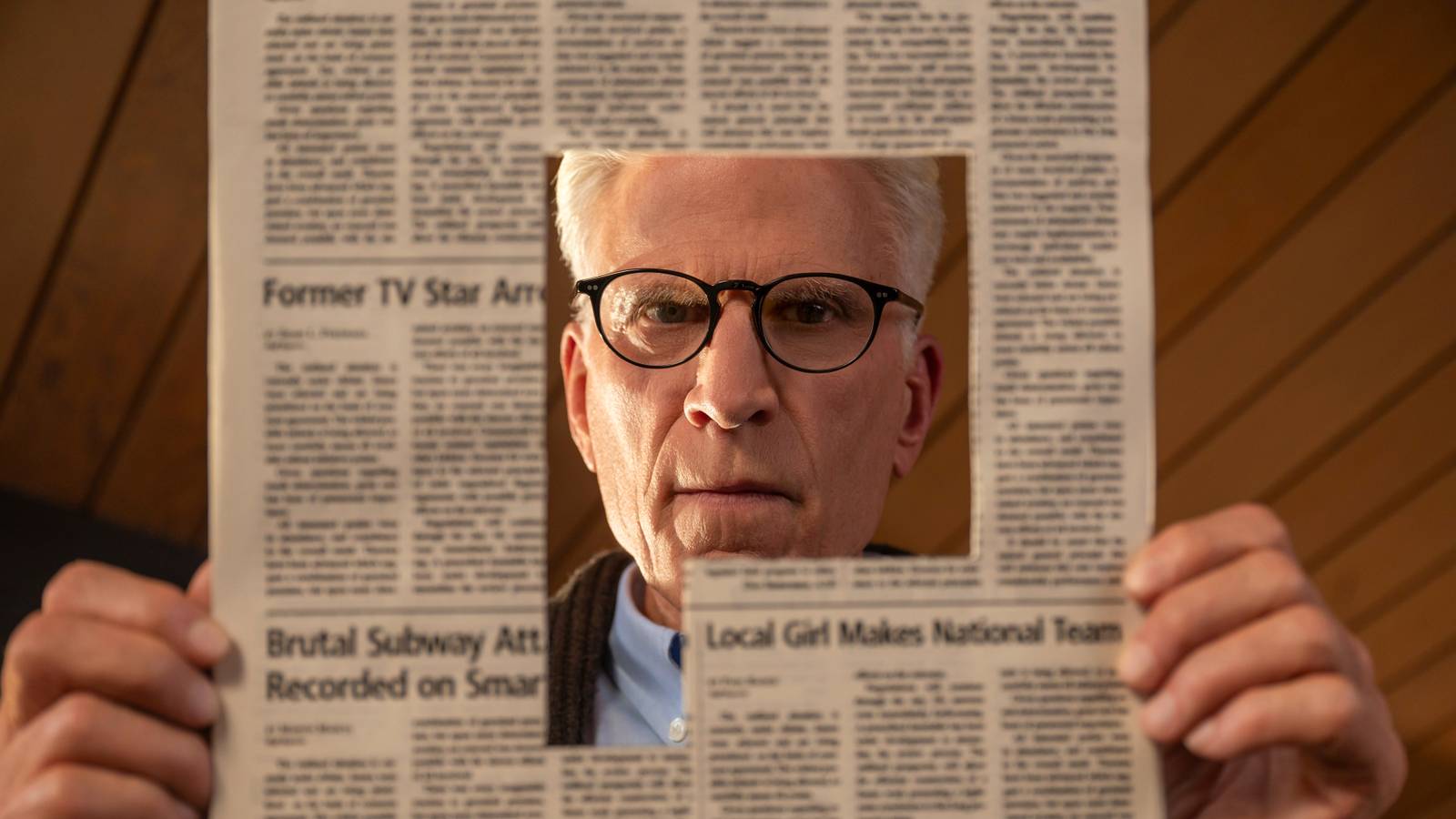 Ted Danson as Charles, holding a newspaper with a cut-out article in Man on the Inside