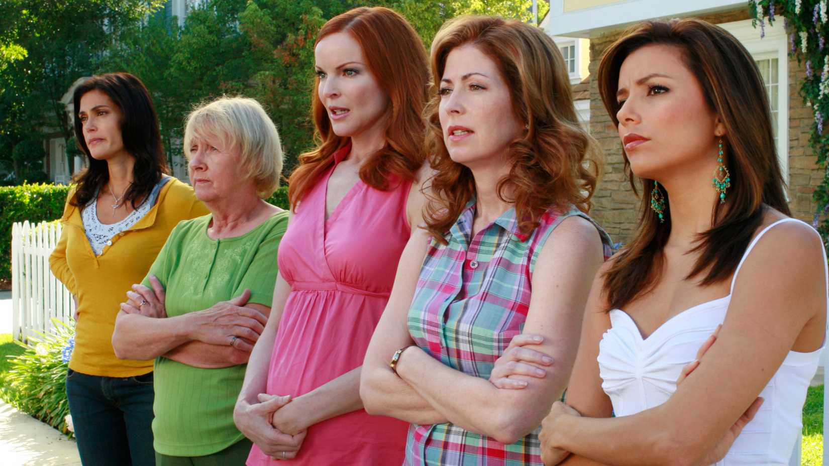 The cast of Desperate Housewives staring at something across the street on Wysteria Lane