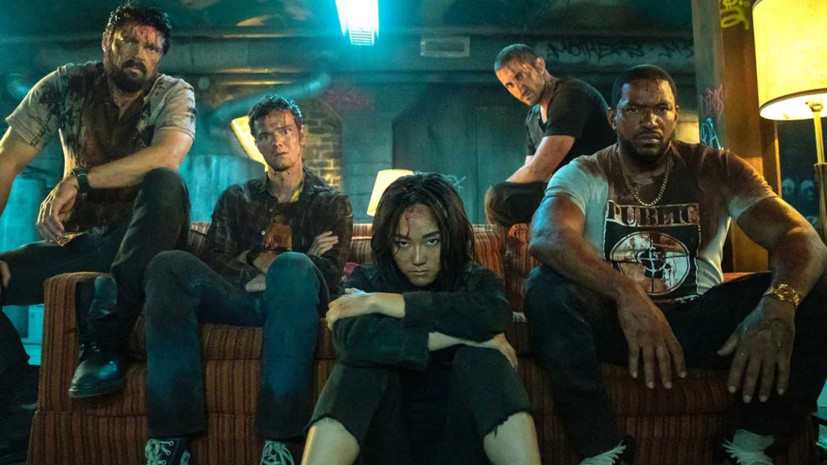 the team sitting on a couch all bloodied up in the boys