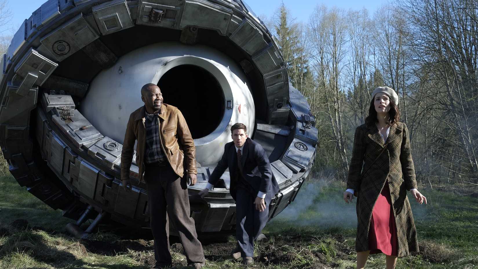 Lucy (Abigail Spencer), Wyatt (Matt Lanter), and Rufus (Malcolm Barrett) come out of a time machine in Timeless.