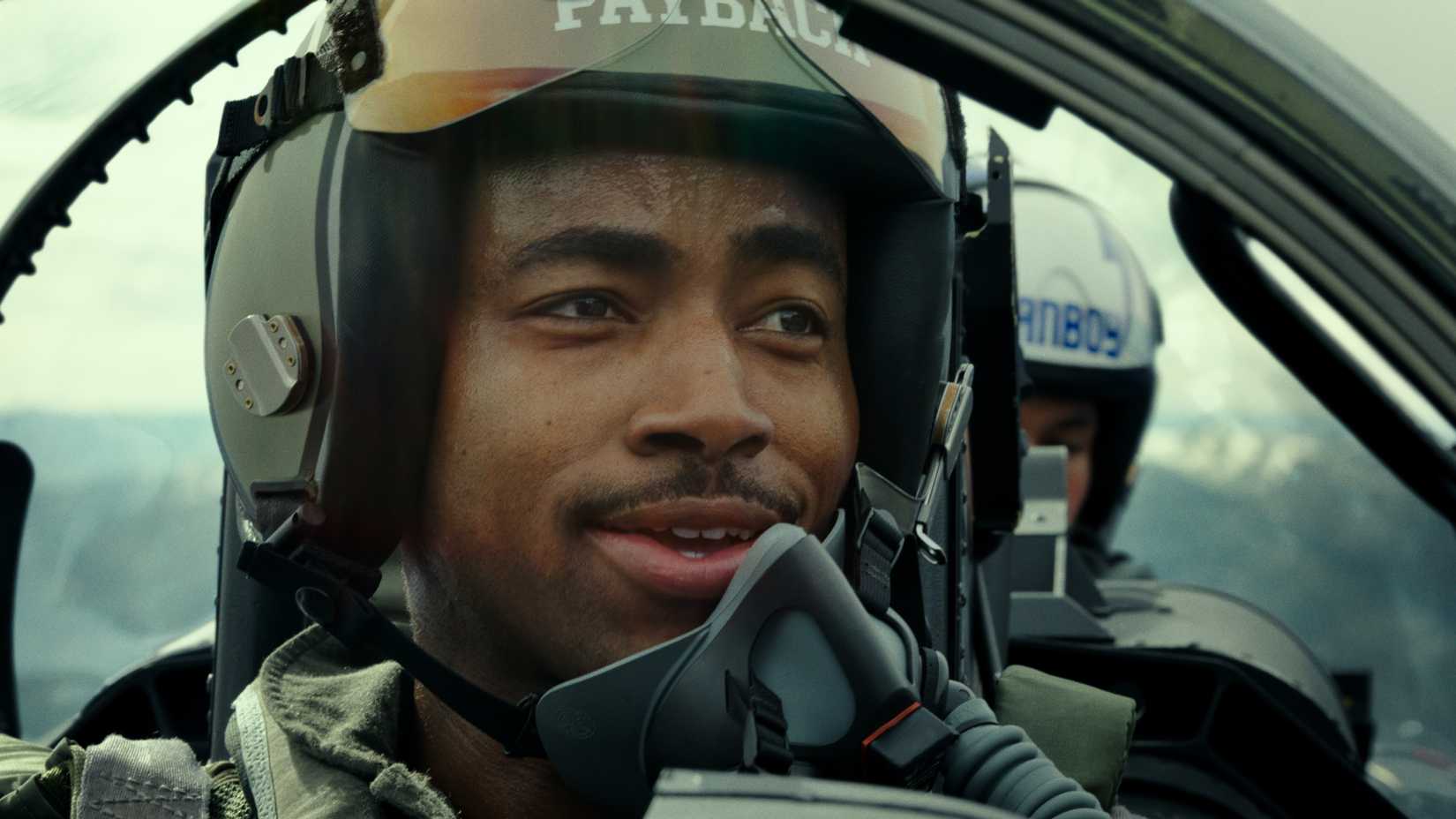 Jay Ellis in uniform and in a cockpit in Top Gun: Maverick