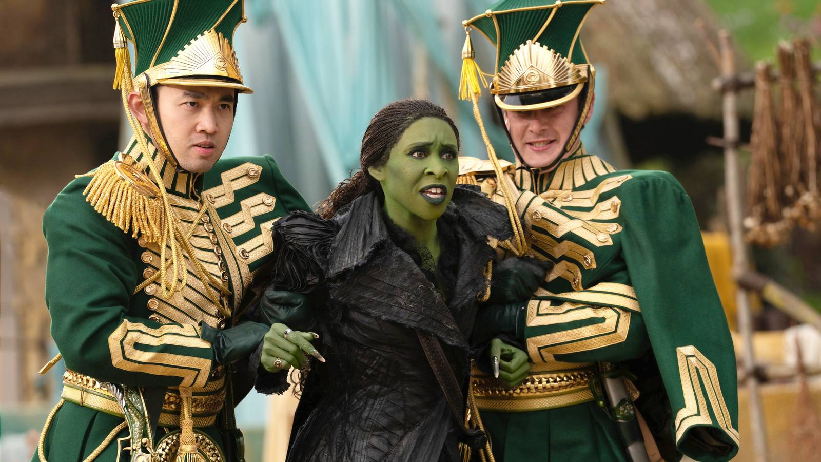 Two Ozian guards restraining a furious Elphaba in Wicked For Good