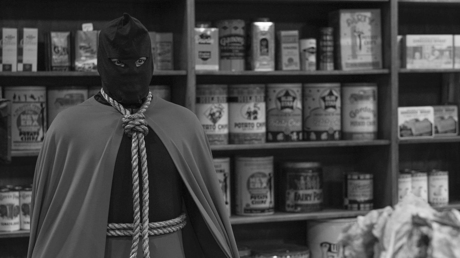 Hooded Justice (Jovan Adepo) standing in a supermarket.