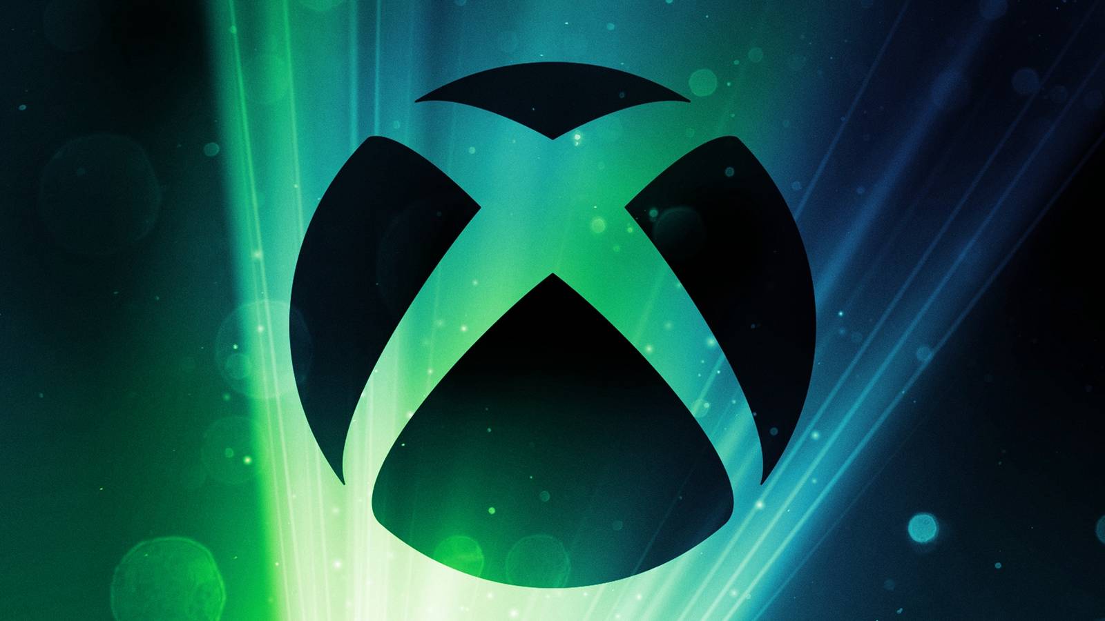 The black Xbox logo is backlit by green lights.