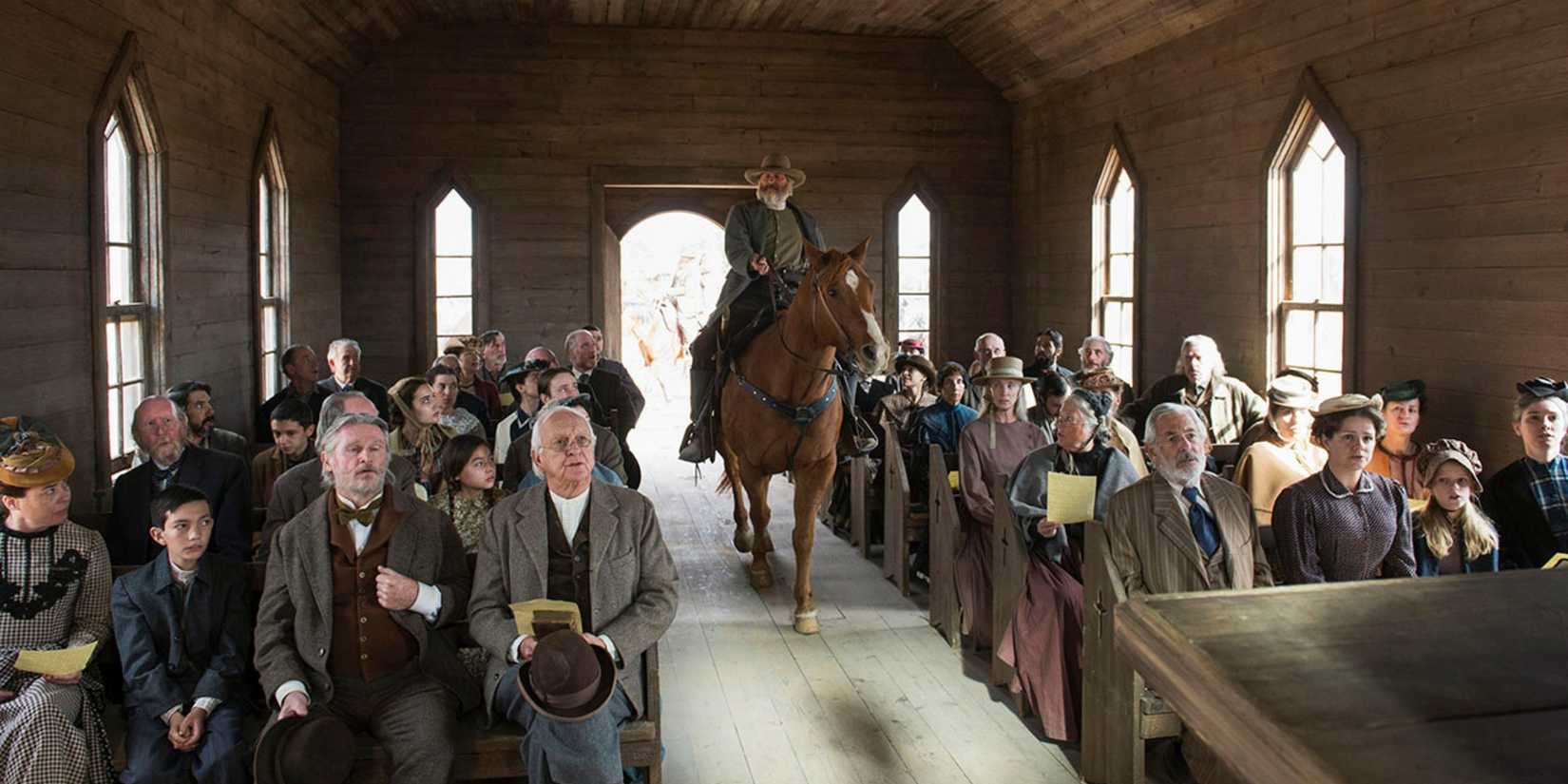 A man on horseback riding into a chuch in Godless on Netflix