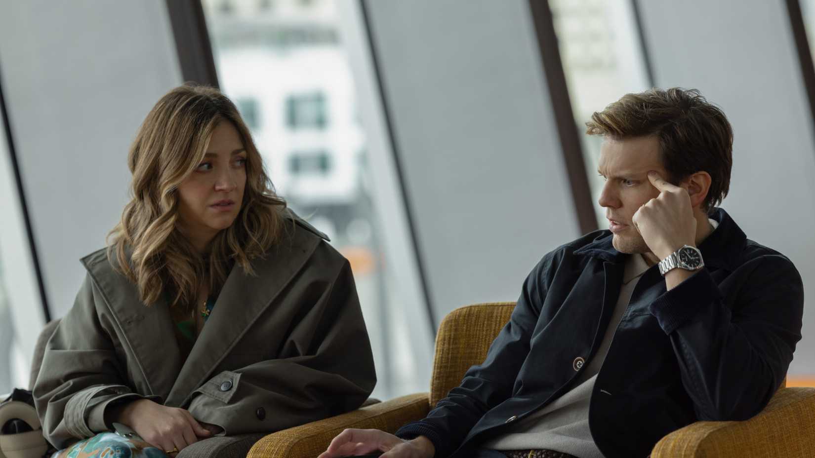 Abby Elliott sitting next to Jake Lacy, both looking worried in All Her Fault episode 2