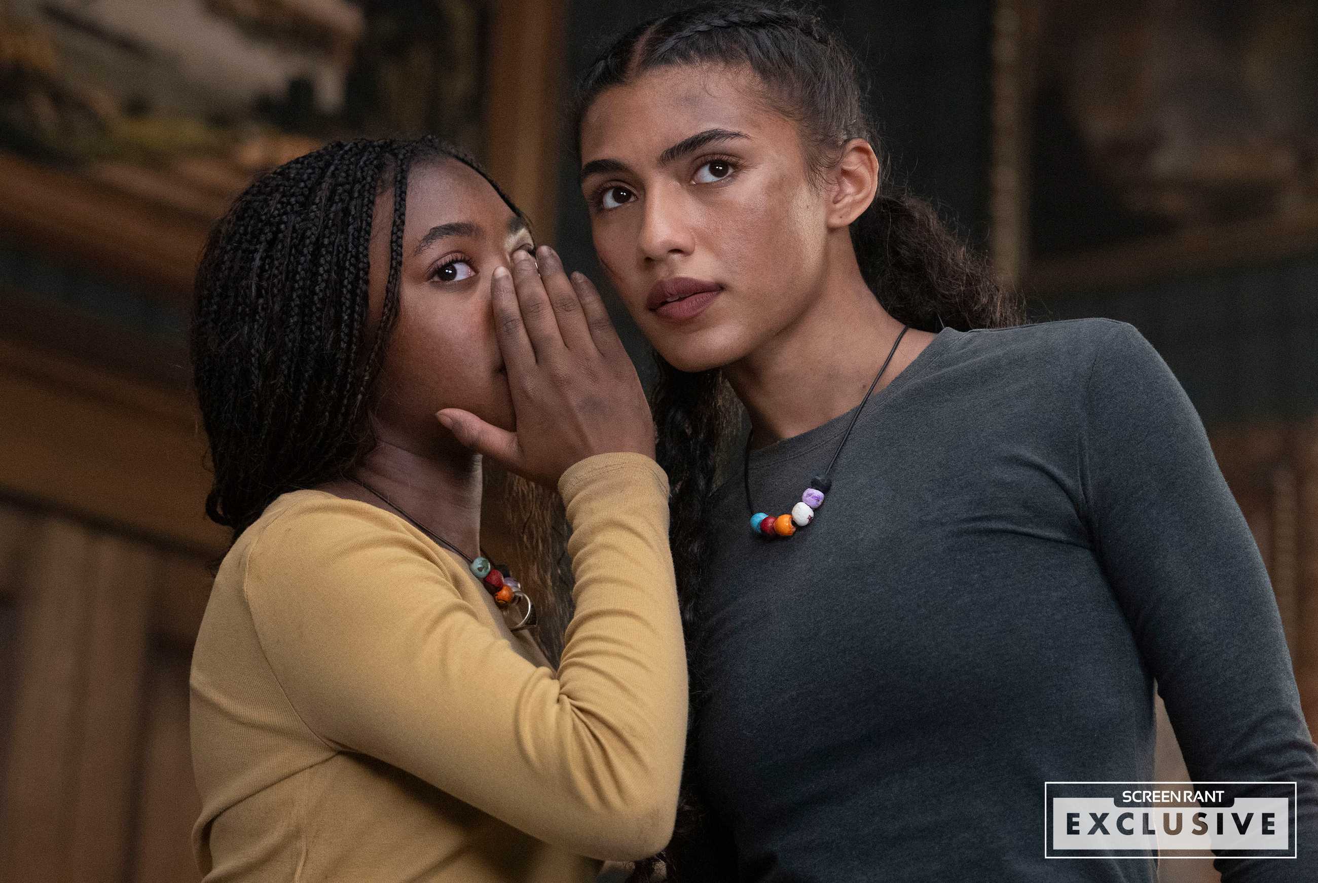 Annabeth (Leah Jeffries) whispers to Clarisse (Dior Goodjohn) in Percy Jackson & the Olympians season 2