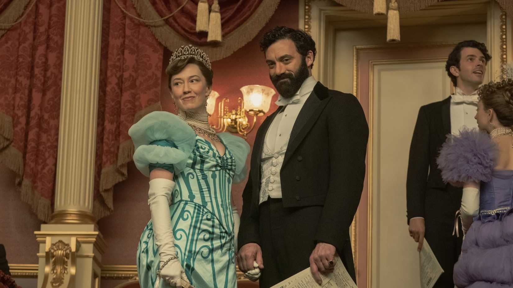 Bertha (Carrie Coon) and George Russell (Morgan Spector) smiling triumphantly in The Gilded Age season 2-1