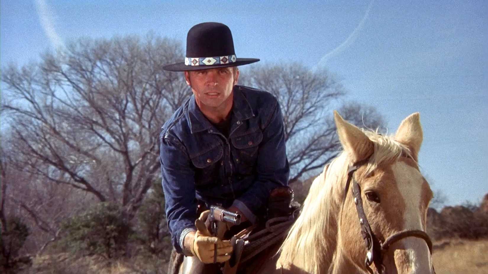 Billy Jack pointing a gun on horseback in Billy Jack (1971)