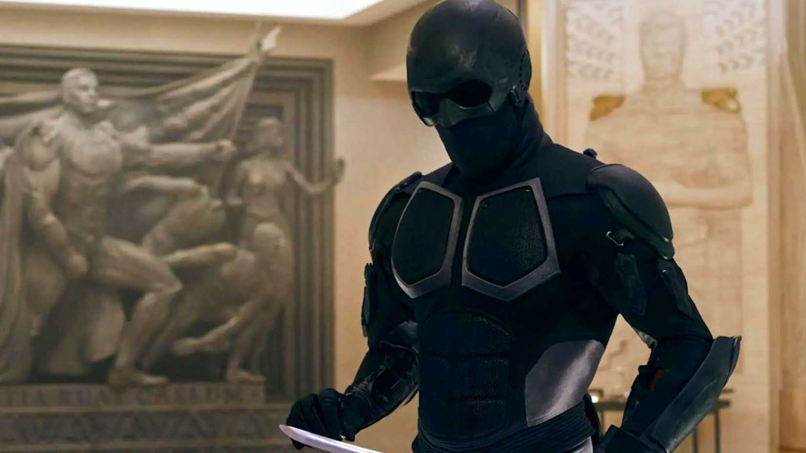 Black Noir studying his sword in The Boys.