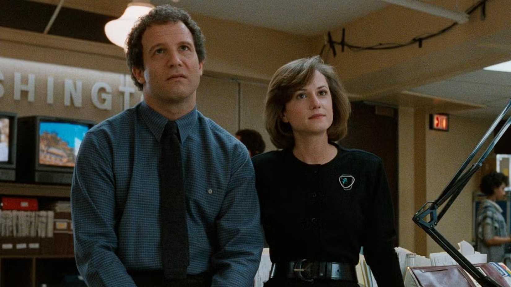 Aaron and Jane watch something in Broadcast News