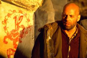 Bruce Willis' James Cole looking tired next to 12 Monkeys graffiti art