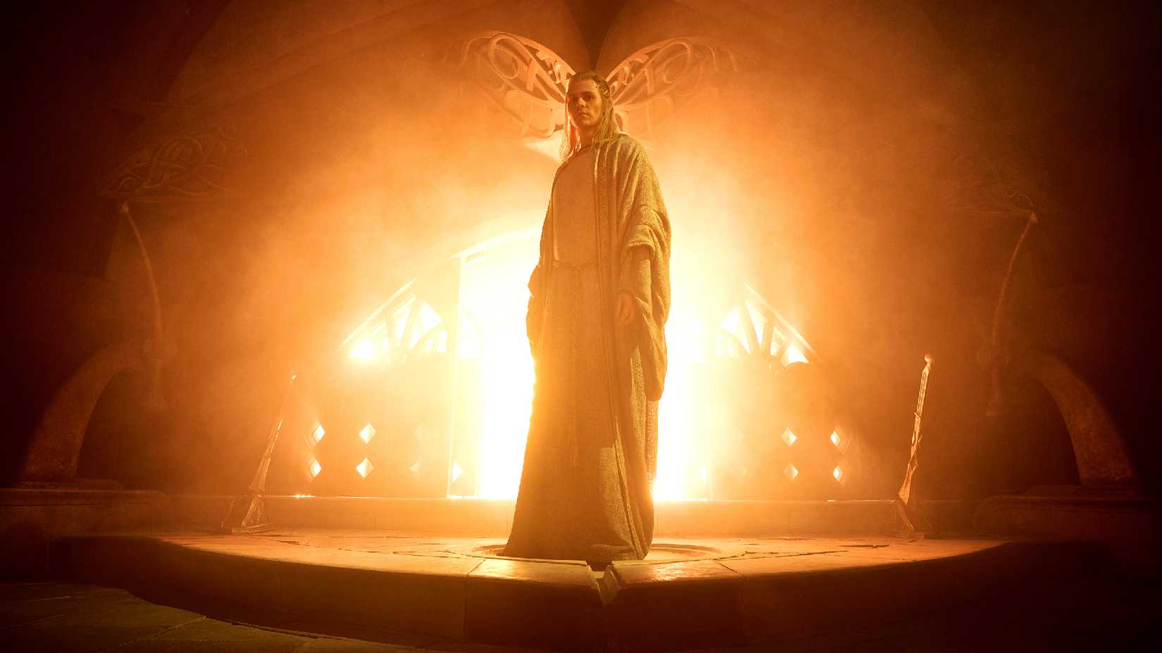 charlie vickers as sauron standing in front of a forge in the rings of power