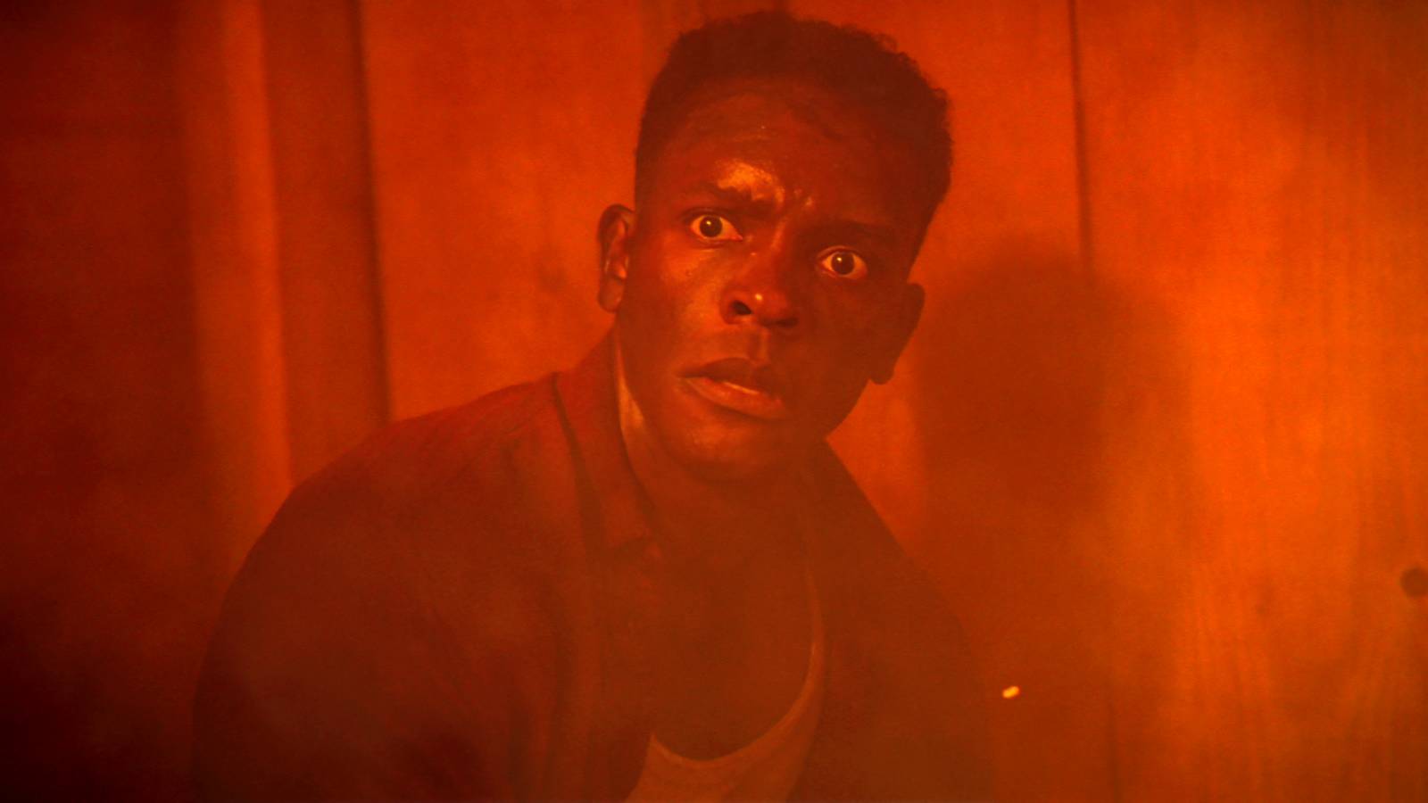 Chris Chalk as Dick looking scared during The Black Spot fire in IT: Welcome to Derry episode 7