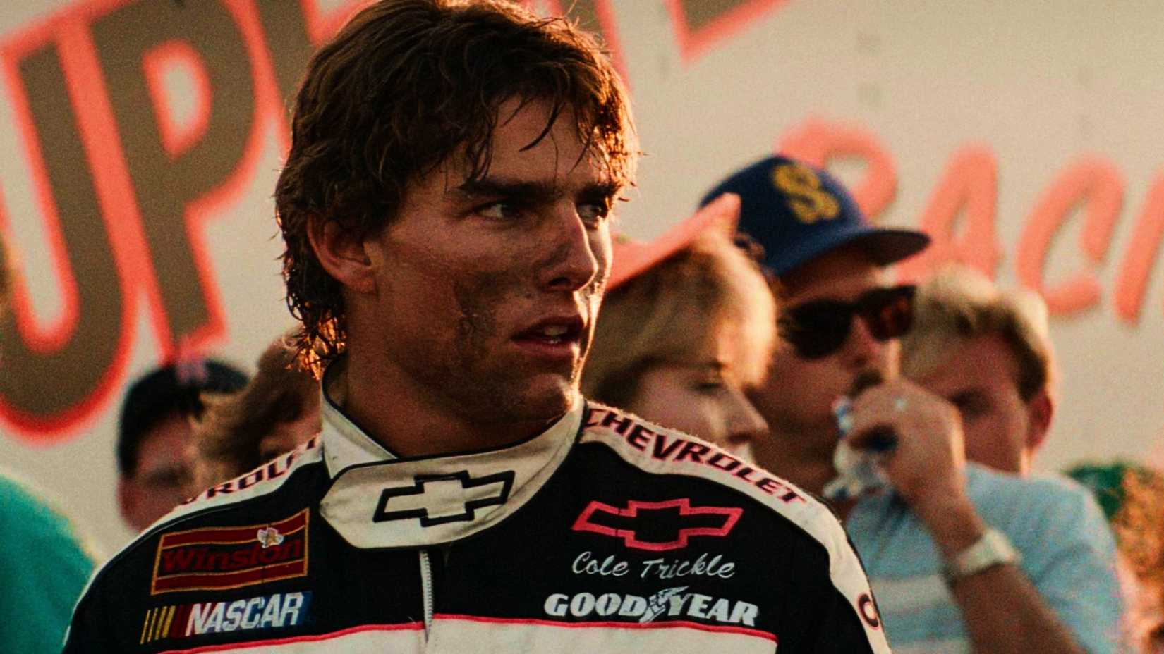 Tom Cruise looks over his shoulder with a dirty face in Days of Thunder