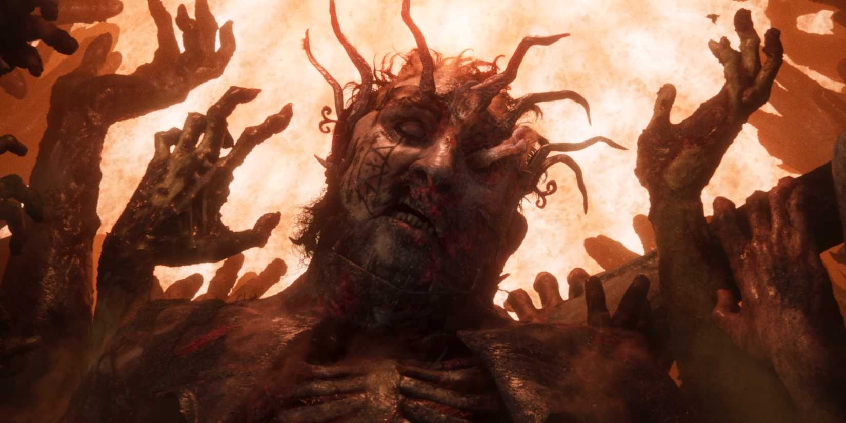 The torso of a man has protruding sticks, while hands emerge near it in a Divinity trailer.