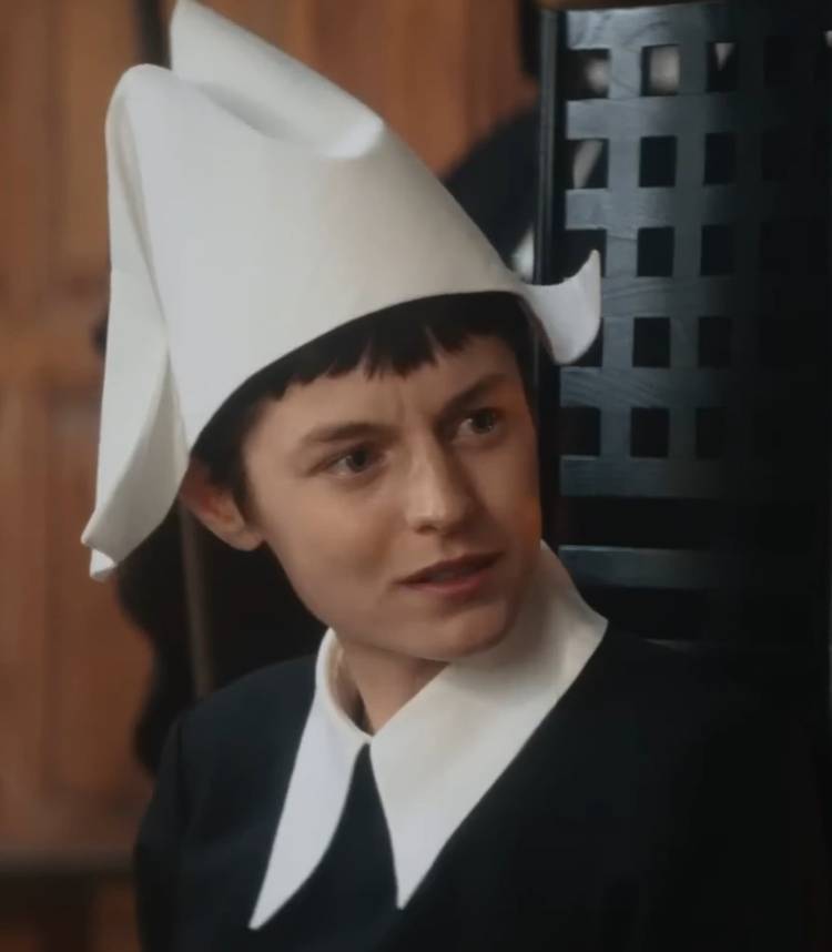 Emma Corrin as Hero looking to the left in shock in 100 Nights of Hero