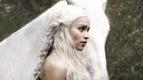 Daenerys (Emilia Clarke) standing in front of a white horse in Game of Thrones.