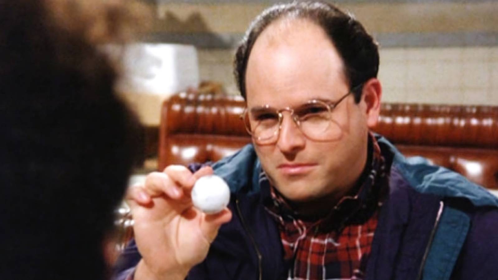 George holding a golf ball in Seinfeld